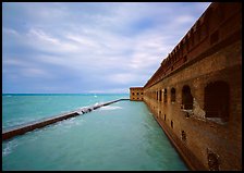 Fort Jefferson massive brick wall overlooking the ocean, cloudy weather. Dry Tortugas National Park, Florida, USA.