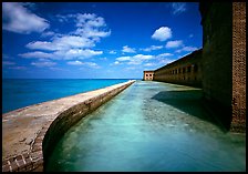 Moat with turquoise waters, seawall, and fort. Dry Tortugas National Park, Florida, USA.