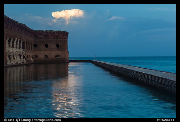 Moat, fort, bright cloud at dawn. Dry Tortugas National Park (color)