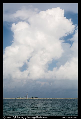 Loggerhead key and lighthouse and tropical cloud. Dry Tortugas National Park, Florida, USA.