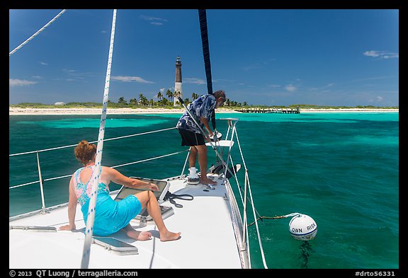 Sailors hooking mooring buoy at Loggerhead Key. Dry Tortugas National Park, Florida, USA.