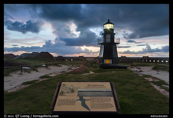 Interpretive sign, Harbor Light, and fort Jefferson. Dry Tortugas National Park, Florida, USA.