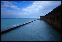 Seascape with fort seawall and moat on cloudy day. Dry Tortugas National Park, Florida, USA.