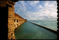 Fort Jefferson wall and moat, framed by cannon window. Dry Tortugas National Park, Florida, USA.