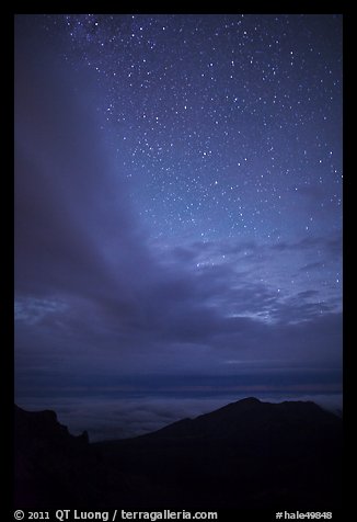 Haleakala Crater ridge and starry sky at night. Haleakala National Park, Hawaii, USA.