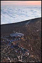 People gather to watch sunrise above sea of clouds. Haleakala National Park ( color)
