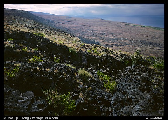 Black lava and coastal plain from Hilana Pali. Hawaii Volcanoes National Park, Hawaii, USA.