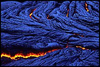 Close-up of ripples of flowing pahoehoe lava at dusk. Hawaii Volcanoes National Park, Hawaii, USA. (color)