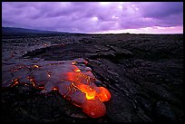 Flowing lava and rain clouds at dawn. Hawaii Volcanoes National Park ( color)