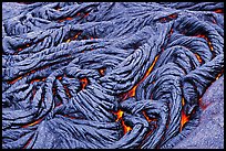 Braids of pahoehoe lava with red hot lava showing through cracks. Hawaii Volcanoes National Park, Hawaii, USA.