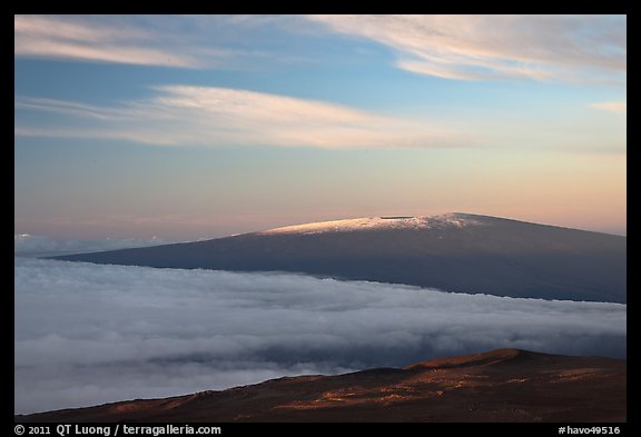 Snowy Mauna Loa above clouds at sunrise. Hawaii Volcanoes National Park, Hawaii, USA.