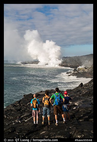 Hikers looking at molten lava and coastal volcanic steam cloud. Hawaii Volcanoes National Park (color)