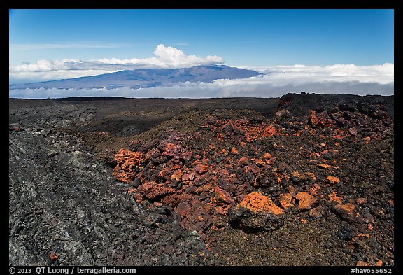 Vein of red and orange lava on Mauna Loa, Mauna Kea in background. Hawaii Volcanoes National Park, Hawaii, USA.