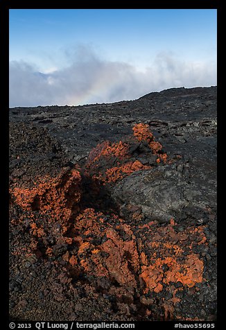 Red and orange lava, rainbow in clouds, Mauna Loa. Hawaii Volcanoes National Park, Hawaii, USA.