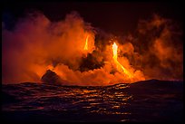 Lava cascades lighting ocean at night. Hawaii Volcanoes National Park ( color)