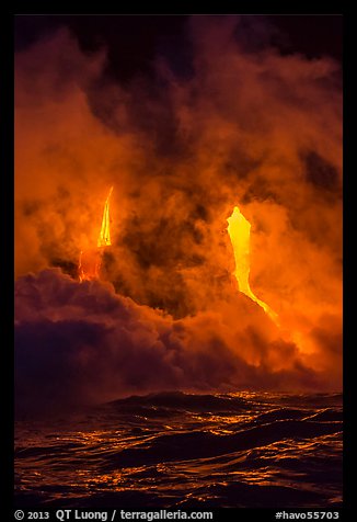 Lava cascading cliffs above ocean waves at night. Hawaii Volcanoes National Park, Hawaii, USA.