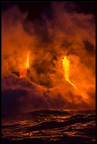 Lava cascading cliffs above ocean waves at night. Hawaii Volcanoes National Park, Hawaii, USA.