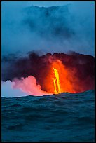 A single spigot of lava creates a large plume steam at sunrise upon reaching ocean. Hawaii Volcanoes National Park ( color)