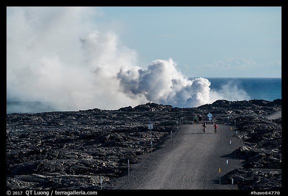 Byciclists and hikers approaching lava ocean entry on emergency road. Hawaii Volcanoes National Park (color)