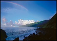 Rainbow and Mataalaosagamai sea cliffs in the distance, Tau Island. National Park of American Samoa