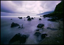 Seascape with smooth water, clouds and rocks, Siu Point, Tau Island. National Park of American Samoa