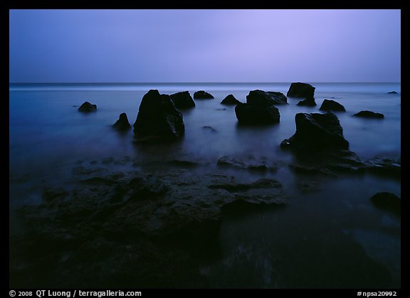Rocks in water at dusk, Siu Point, Tau Island. National Park of American Samoa (color)