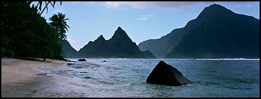 Tropical peaks raising abruptly above beach, Ofu Island. National Park of American Samoa (Panoramic color)