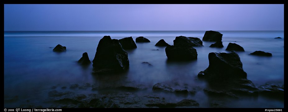 Seascape with boulders in water at dusk. National Park of American Samoa (color)