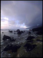 Boulders and coastline at sunrise with rainbow, Siu Point, Tau Island. National Park of American Samoa (color)