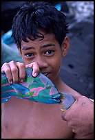 Samoan boy with freshly catched tropical fish, Tau Island. National Park of American Samoa (color)