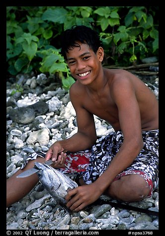 Samoan boy with fish, Tau Island. National Park of American Samoa