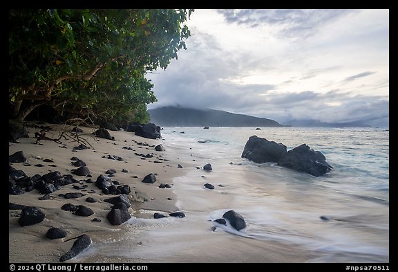 Beach with rocks and Olosega Island. National Park of American Samoa