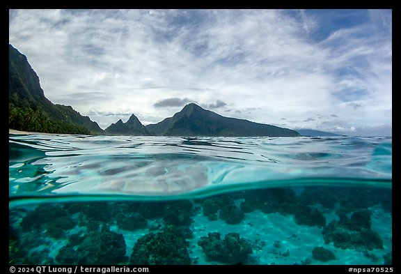 Over-under split view of Ofu South Beach Lagoon and jagged mountains. National Park of American Samoa
