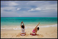 Young women stretching on Waimanalo Beach. Oahu island, Hawaii, USA ( color)