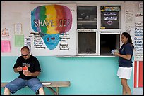 Shave ice store with man sitting eating and woman ordering, Waimanalo. Oahu island, Hawaii, USA (color)