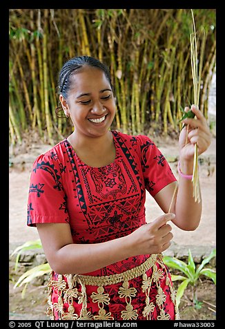 Tonga woman showing how to make cloth out of Mulberry bark. Polynesian Cultural Center, Oahu island, Hawaii, USA