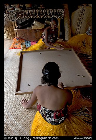 Fiji women playing a traditional game similar to pool. Polynesian Cultural Center, Oahu island, Hawaii, USA (color)