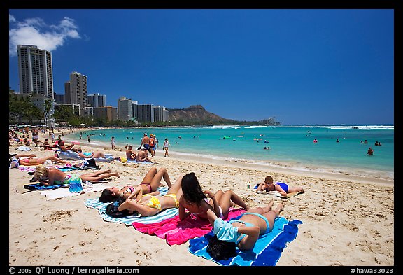 Young women sunning on Waikiki Beach. Waikiki, Honolulu, Oahu island, Hawaii, USA