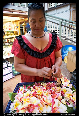 Woman preparing a fresh flower lei, International Marketplace. Waikiki, Honolulu, Oahu island, Hawaii, USA (color)