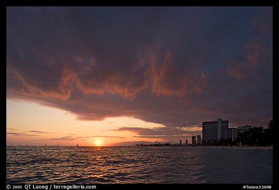 Sun setting and Honolulu skyline. Waikiki, Honolulu, Oahu island, Hawaii, USA