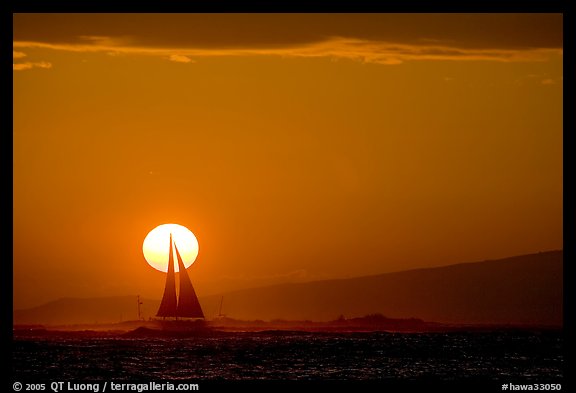 Sailboat and sun disk, sunset. Waikiki, Honolulu, Oahu island, Hawaii, USA