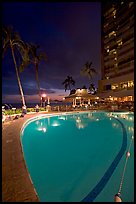 Swimming pool at night, with dance performance, Sheraton hotel. Waikiki, Honolulu, Oahu island, Hawaii, USA