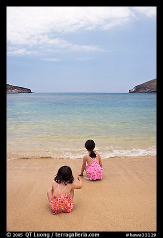 Two girls at the edge of water, Hanauma Bay. Oahu island, Hawaii, USA