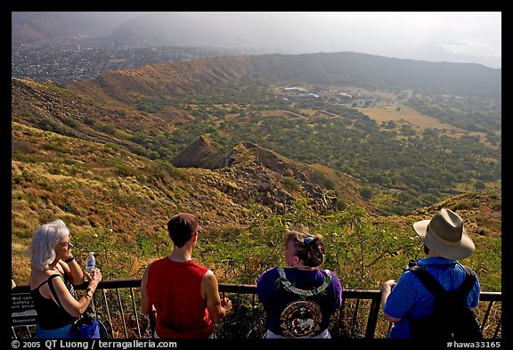 Tourists look at the  Diamond Head crater, early morning. Oahu island, Hawaii, USA