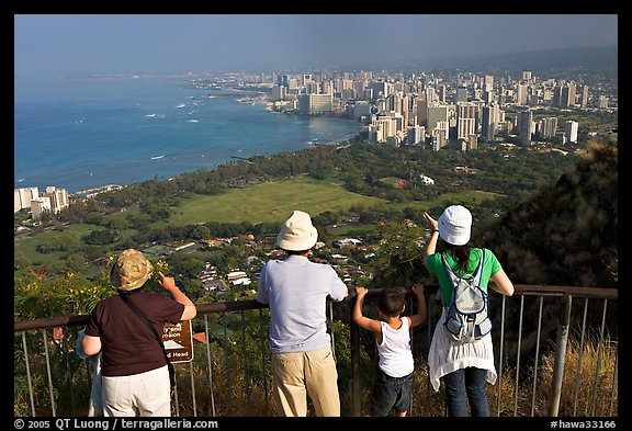 Tourists look at Waikidi from the  Diamond Head crater, early morning. Oahu island, Hawaii, USA