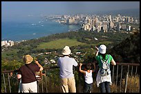 Tourists look at Waikidi from the  Diamond Head crater, early morning. Oahu island, Hawaii, USA (color)