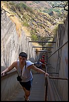 Tourist climbing a staircase on the Diamond Head summit trail. Oahu island, Hawaii, USA (color)