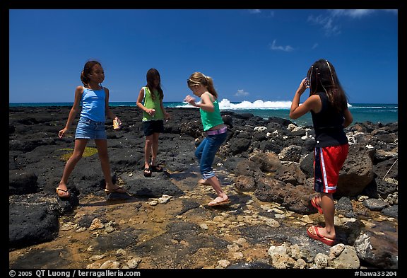 Girls playing in tidepool, Kukuila. Kauai island, Hawaii, USA (color)