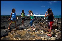 Girls playing in tidepool, Kukuila. Kauai island, Hawaii, USA