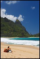 Woman sitting on a beach chair on Tunnels Beach. North shore, Kauai island, Hawaii, USA (color)